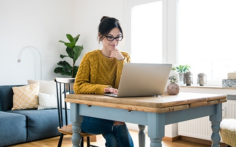 Woman sitting at desk on laptop