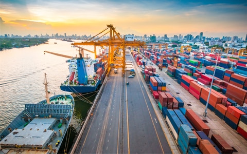 image of a port with ships loading and unloading cargo trailers, 4 Ways Freight Brokers Can Help Prevent Strategic Cargo Theft
