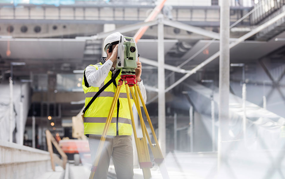 construction worker surveying site for vibration damage risks