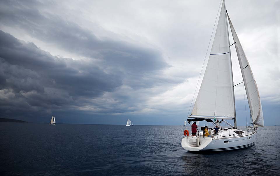 Boat sailing away from oncoming storm