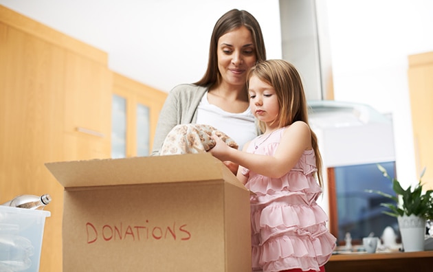 Woman packing boxes with daughter