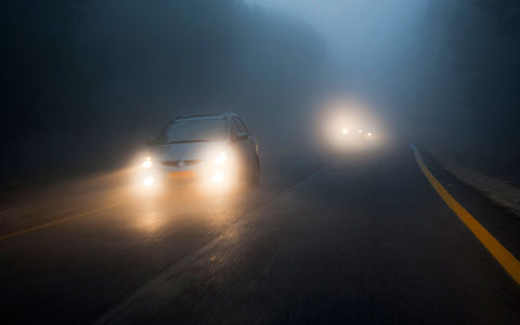 Cars driving in fog at night