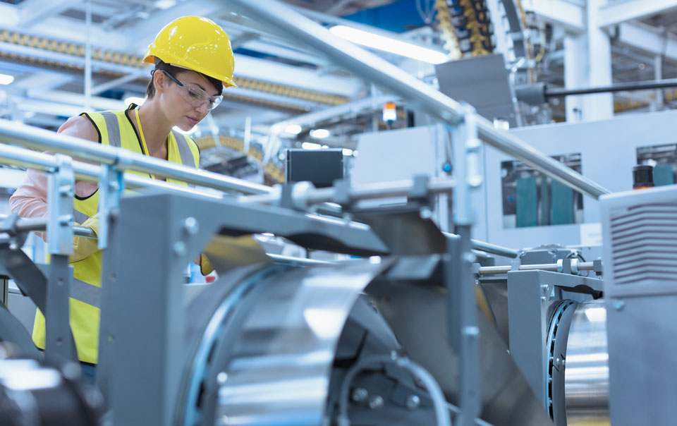 Woman looking at equipment in manufacturer
