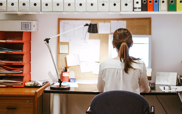 Woman sitting ergonomically correct at your desk and workstation