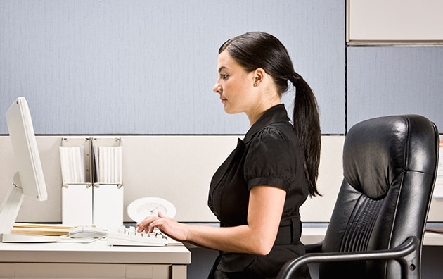 Woman sitting ergonomically correct at her desk