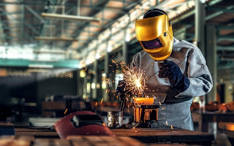 welder with yellow safety mask