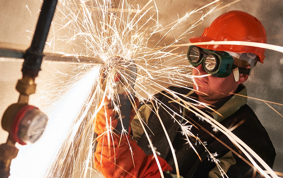 Construction worker welding as part of hot work operations
