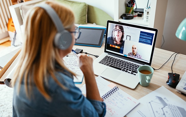 woman wearing a headset is on a video conference call. How to Achieve Sales Goals and Improve Marketing
