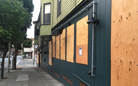 Image of boarded up business. How to Protect Your Business Property During Times of Civil Unrest