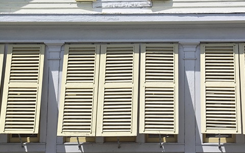 hurricane shutters on the side of a house