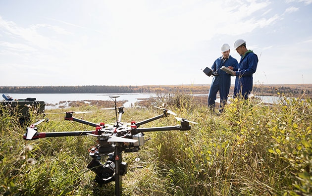 Professionals using drones on the job in a field