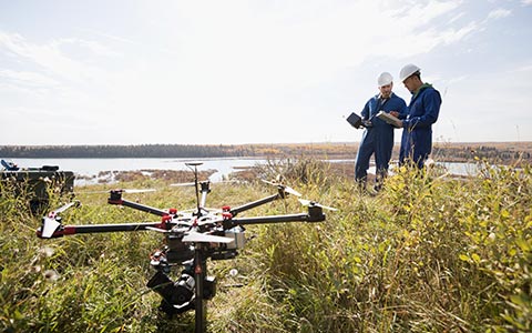 commercial employees using drone to monitor land