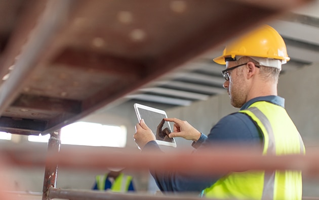 construction worker using a tablet