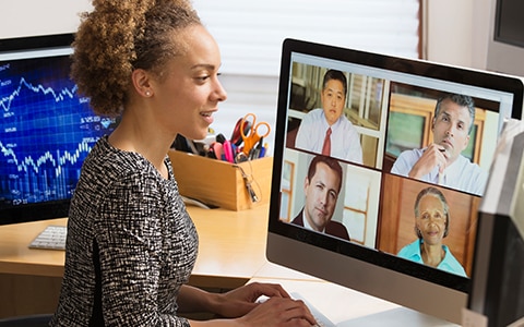 A woman working from home is on a video conference call. Managing Remote Workers During COVID-19