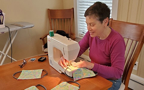 woman sewing face masks