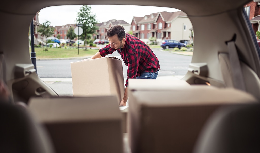 man packing his car for moving out of his home