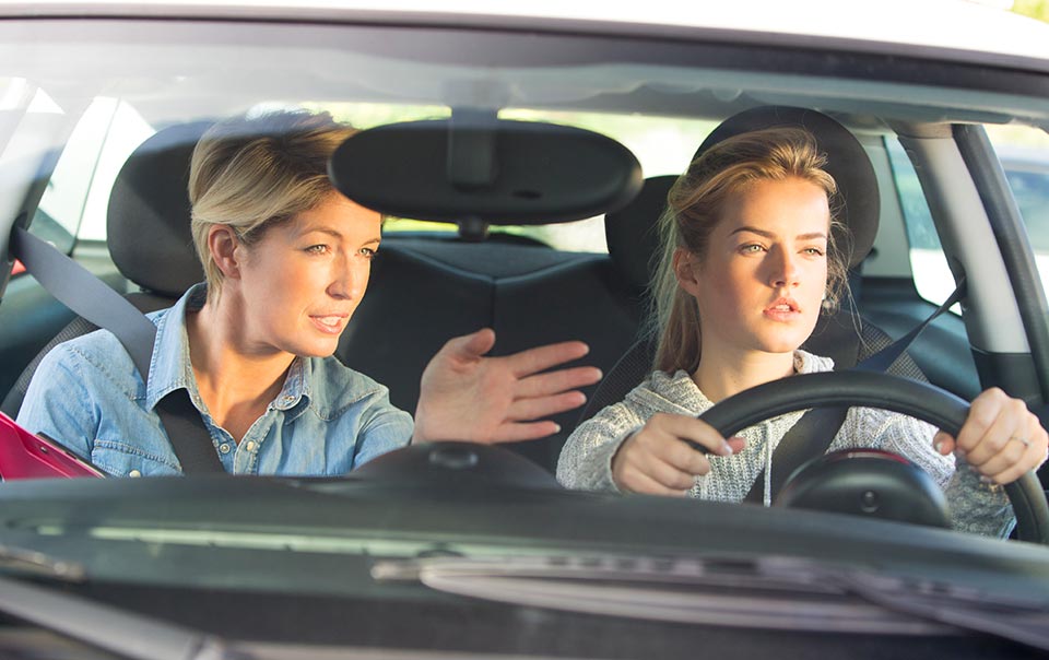 Parent and teen driving behind the wheel