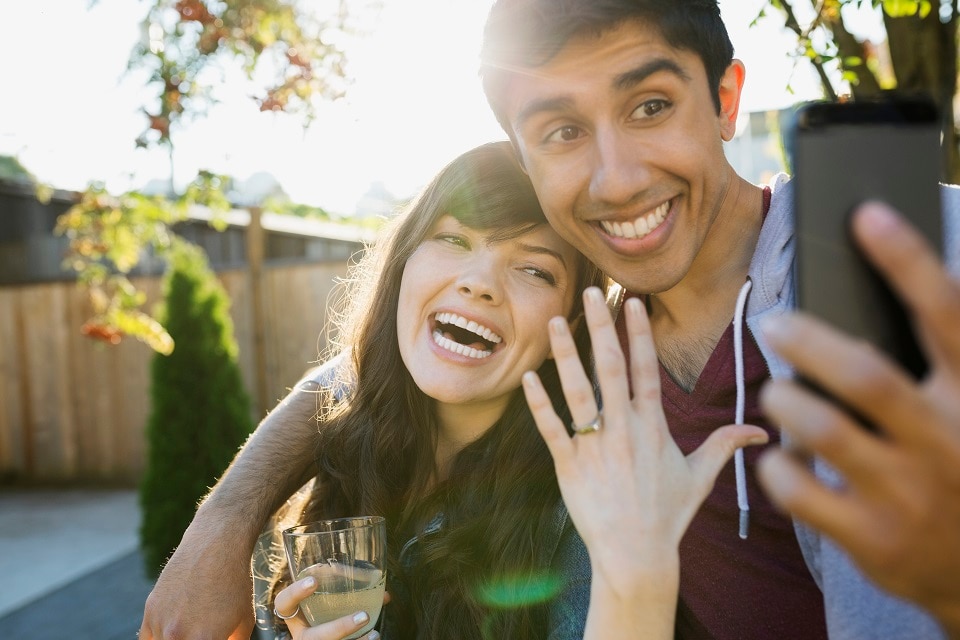 man and woman take a selfie after getting engaged