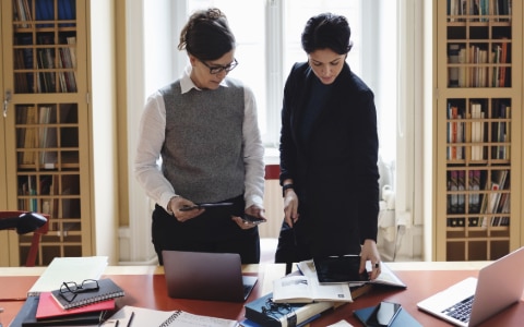 two women looking at paperwork
