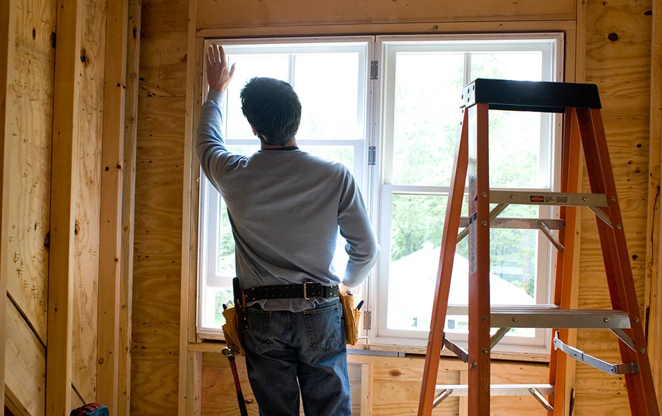 person working on installing new window in house
