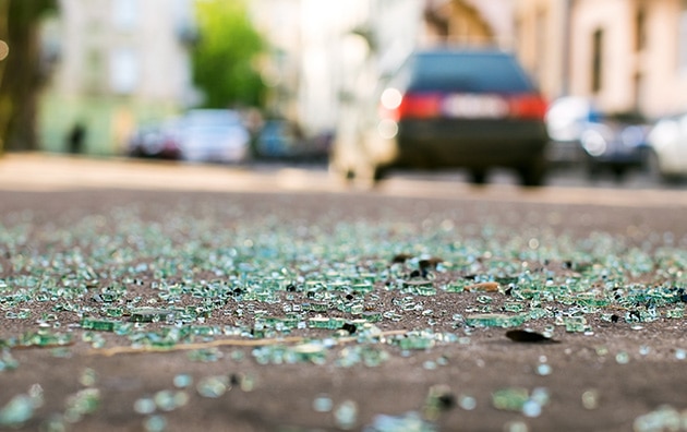 broken glass on a road after a car accident