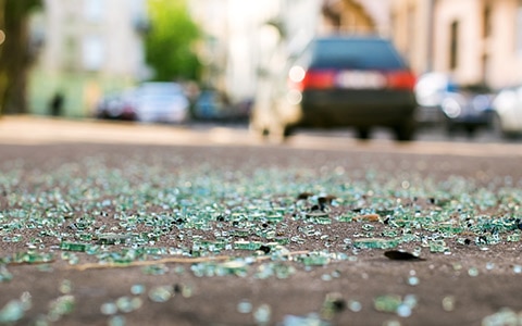 broken glass on road after car accident