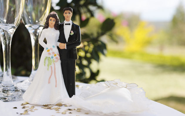 Cake topper of married couple on a table