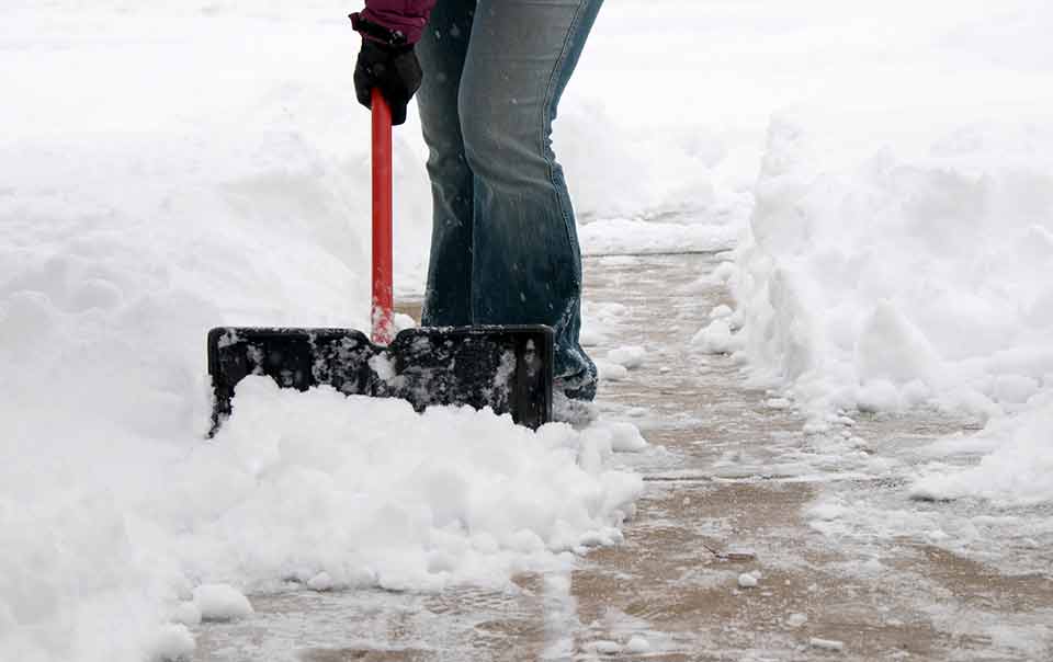Person shoveling their sidewalk